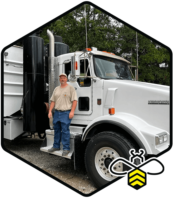 Driver standing on vacuum truck in Raleigh & Fayetteville
