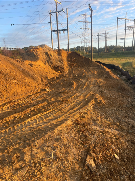 Cleared land with excavated soil for geotechnical analysis in Fayetteville